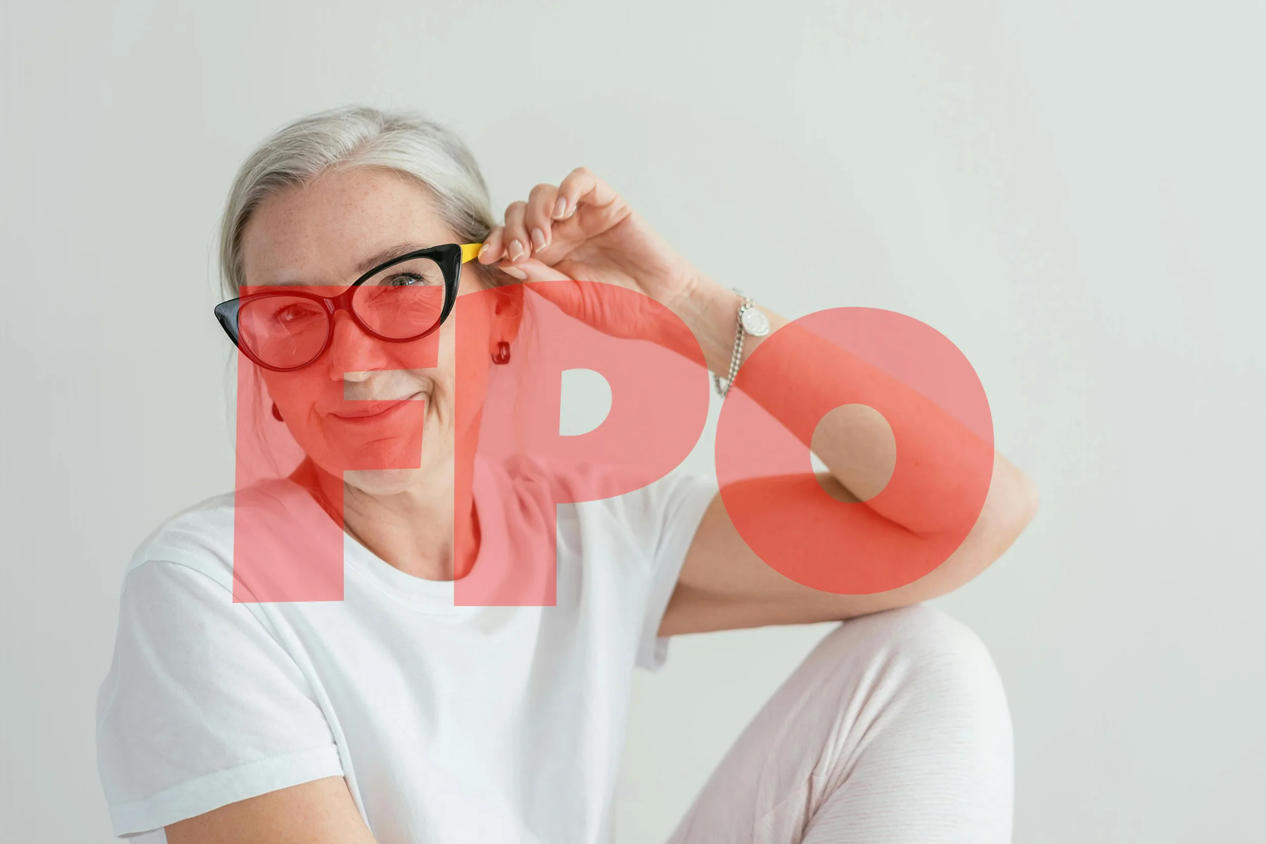 Lady wearing all white and glasses smiles