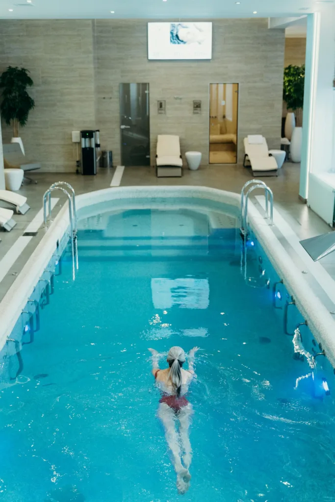 Woman going for a swim in an indoor pool