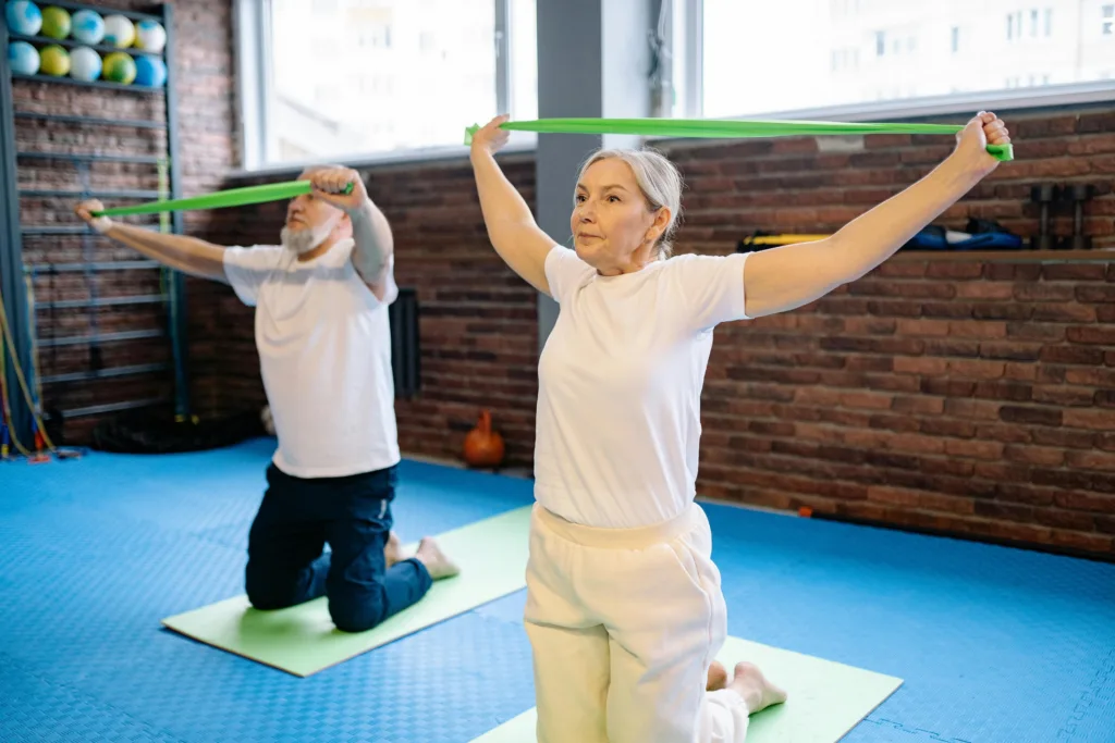 A woman and man doing gentle arm exercises together