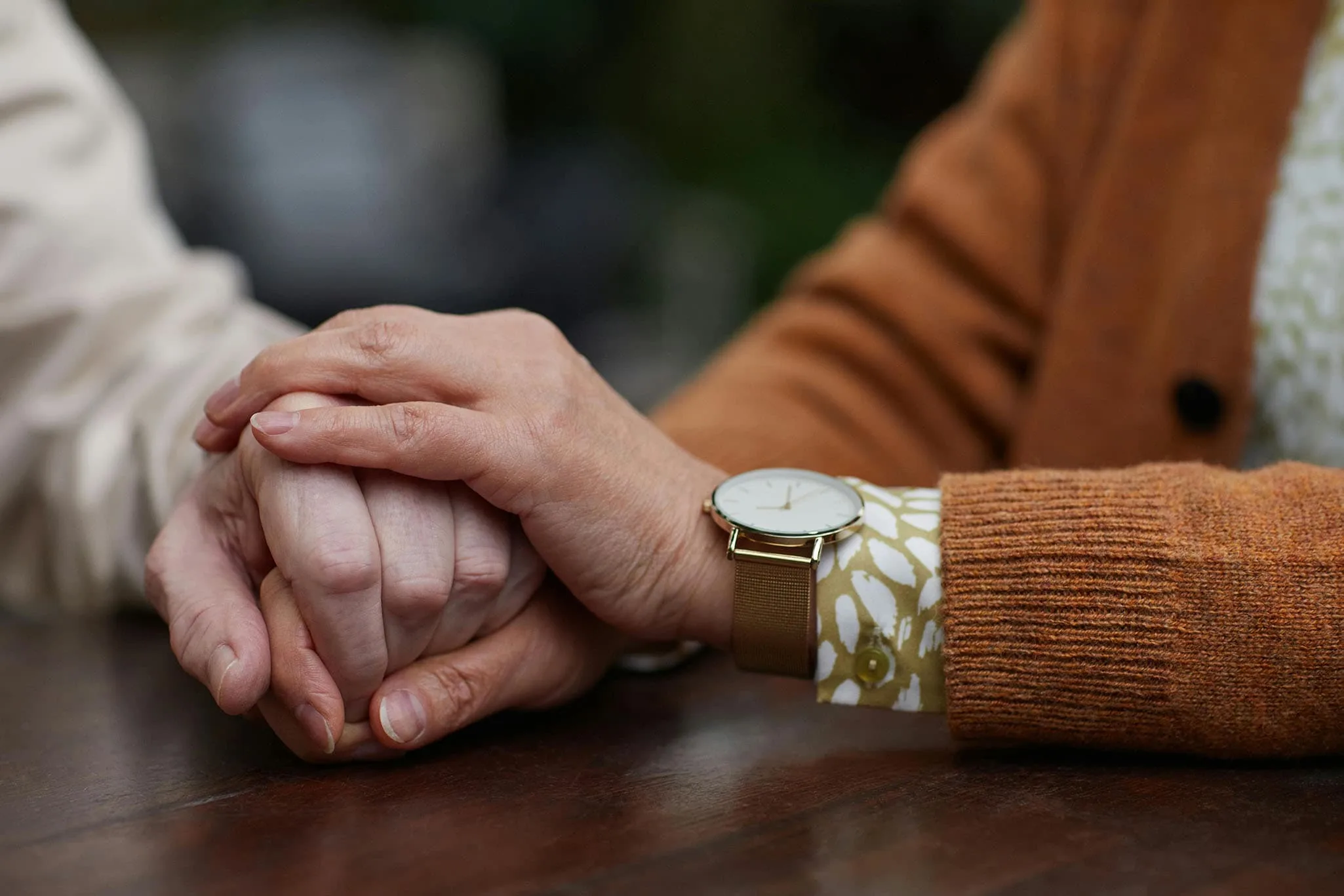 Close up of two seniors holding hands