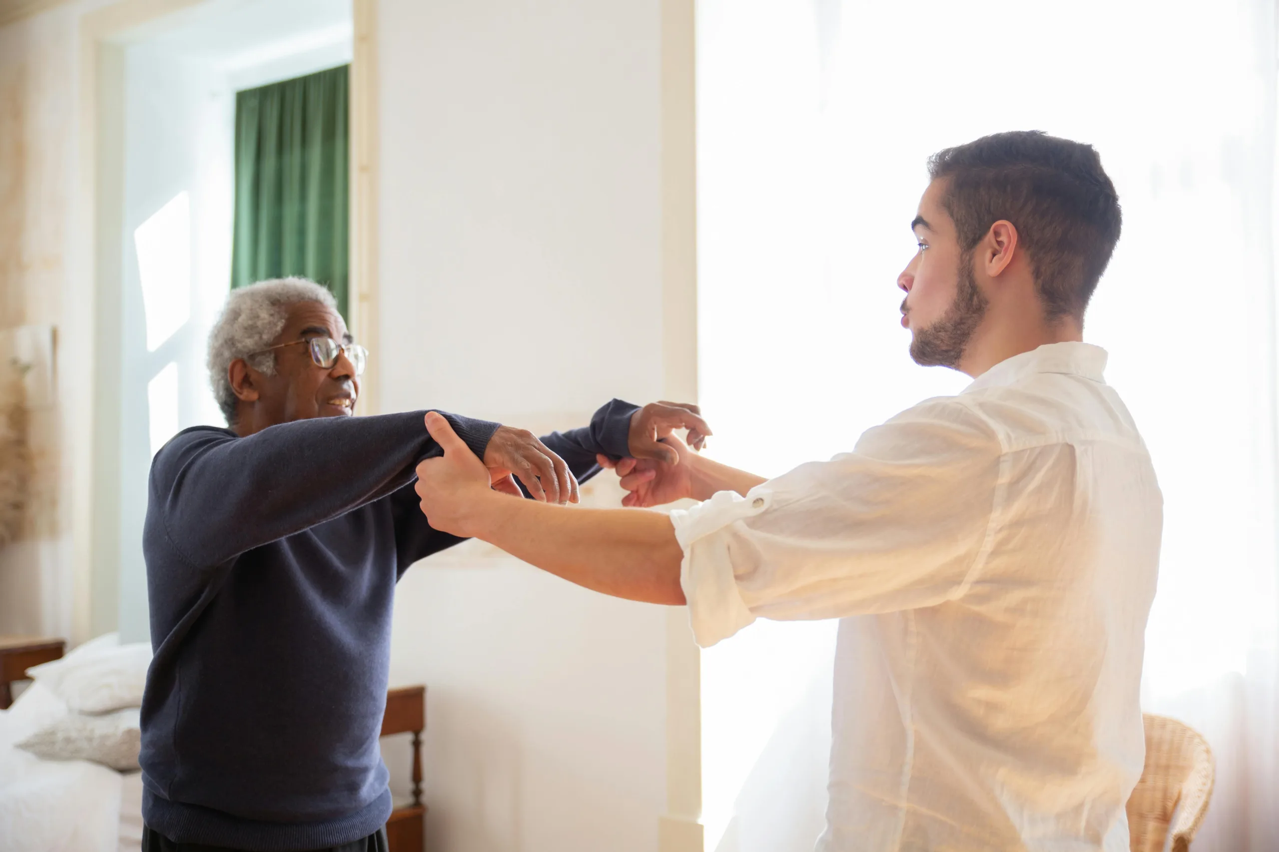 A nurse helping a senior gently stretch